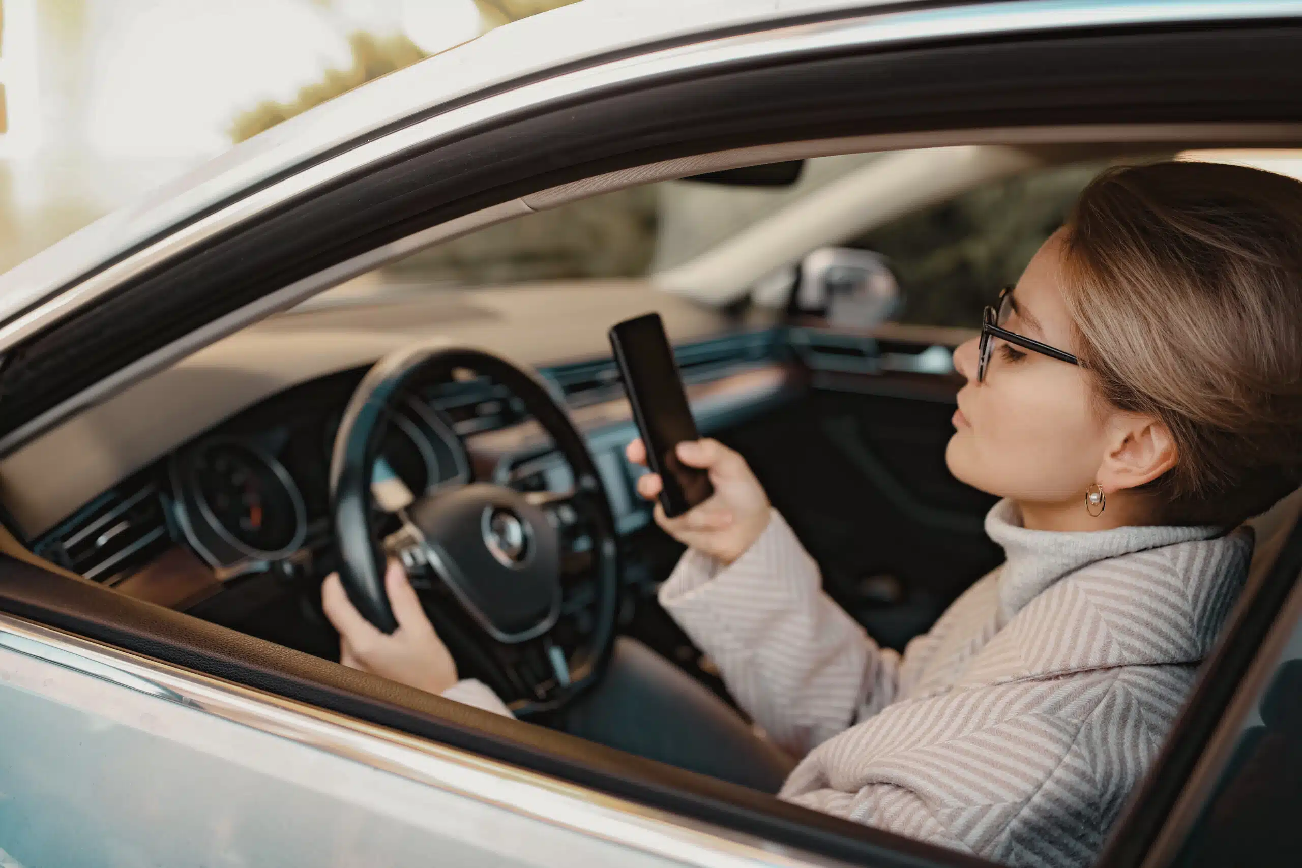 Person on the Phone Texting and Driving | Distracted Driving Impacts | ATA Associates